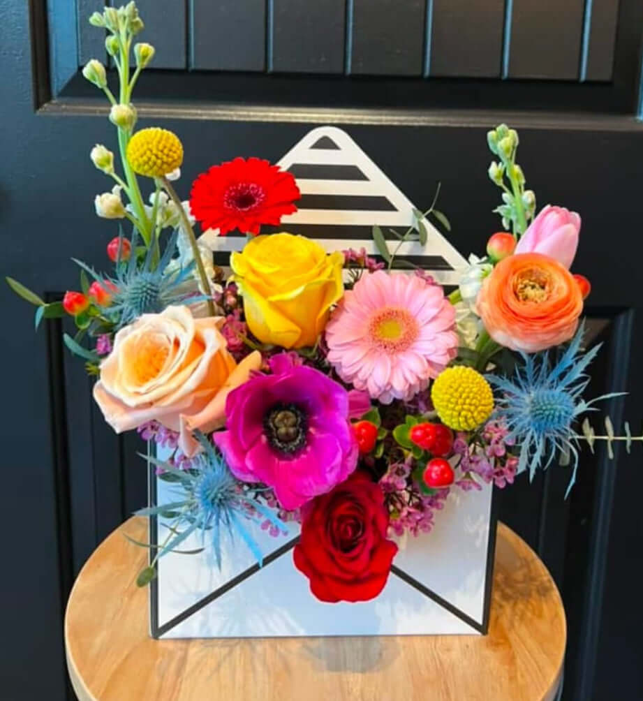 Love Letter Flower Arrangement in a paper letter box with colorful blooms for flower delivery Brentwood CA 94513.