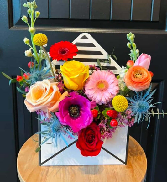 Love Letter Flower Arrangement in a paper letter box with colorful blooms for flower delivery Brentwood CA 94513.