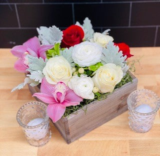Flower arrangement in wood box.  Colors are light pink, cream, gray foliage, and a pop of red roses.  Very pretty and makes a great floral gift.  Shipped overnight.
