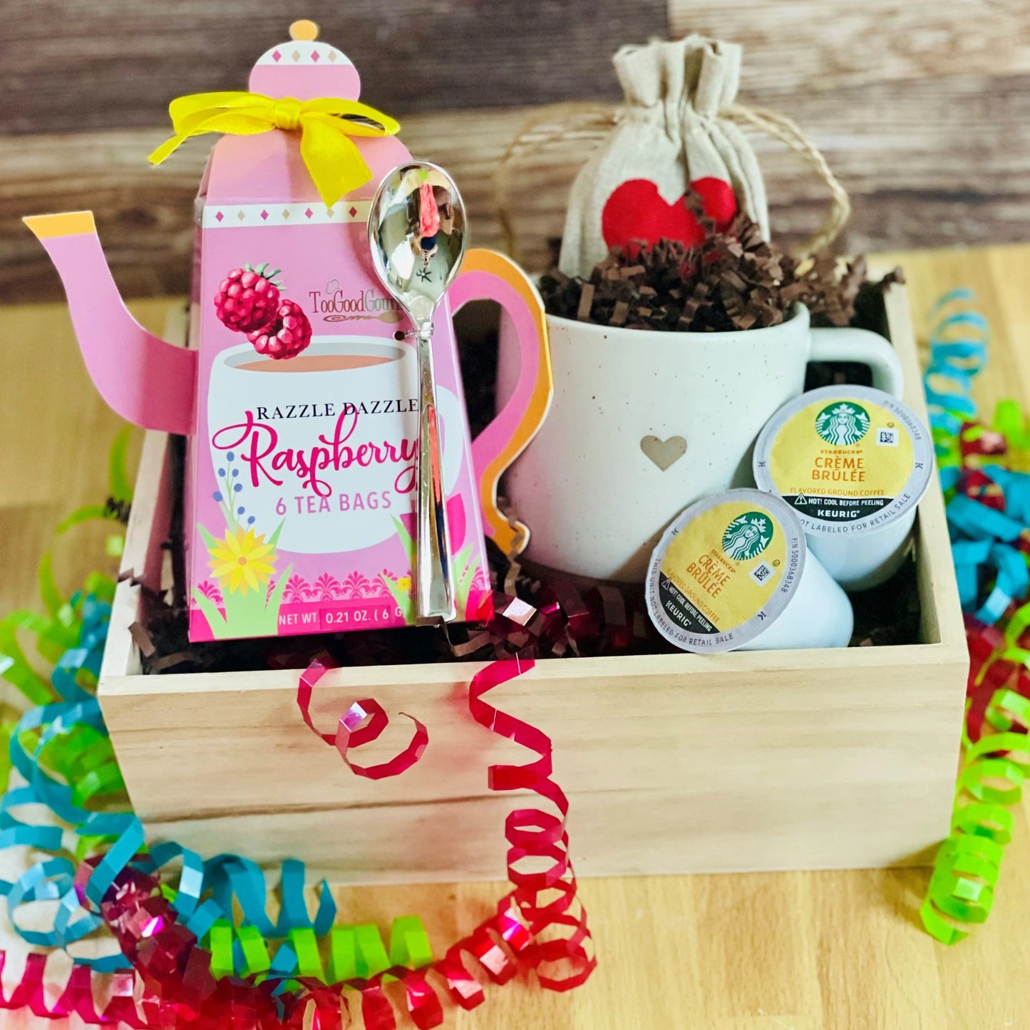 Coffee and Tea Gift Basket.  A cute box with raspberry tea, a super cute mug with a heart on it, and two Kerig Coffee bods will make a great Birthday or Co-worker gift for the holidays