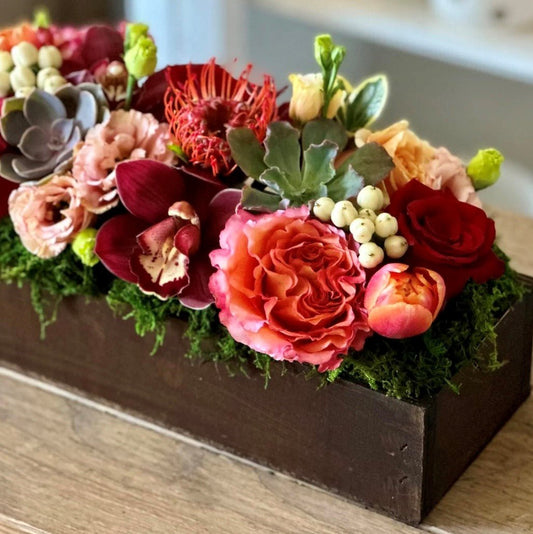 Flower arrangement delivery in mail with orange and red and cream flowers.  Great for Fall.